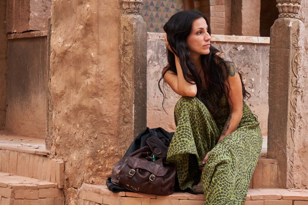 Woman on street between ancient buildings