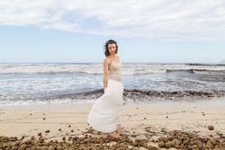 Charming young woman on shore near water