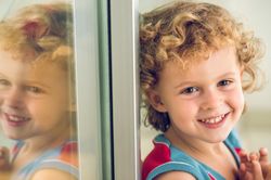 Happy boy sitting near window