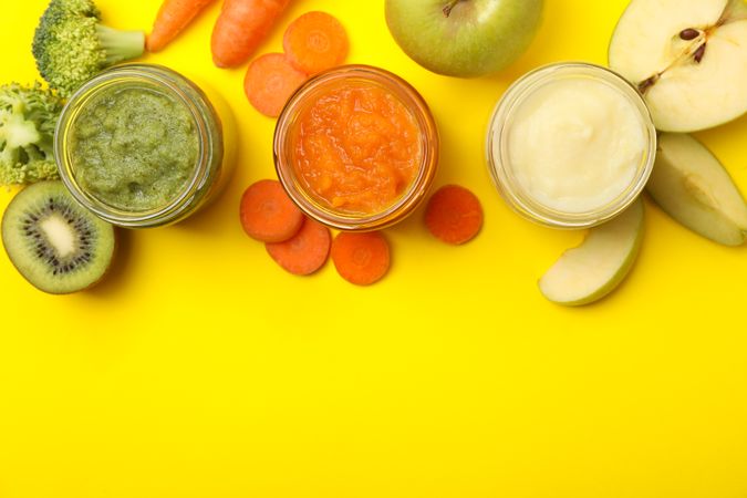 Composition with vegetable puree on yellow background. Baby food