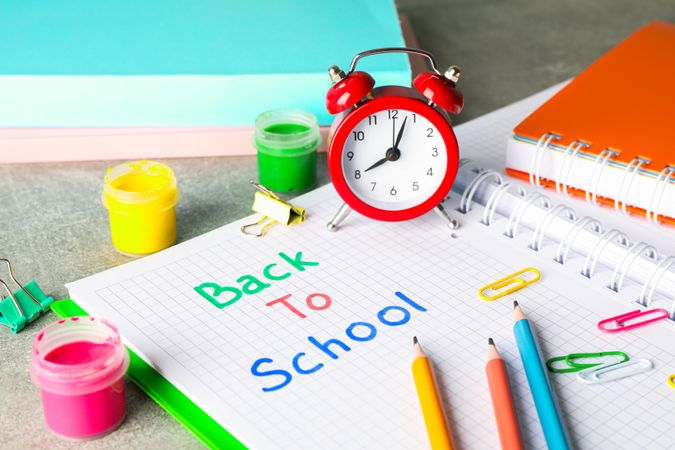 Composition with school supplies on grey background, space for text