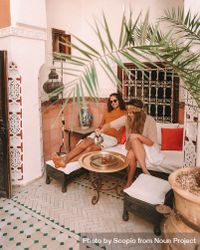 Man and woman sitting and drinking tea in Moroccan style interior 4ZQ3W5