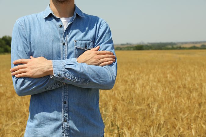 Young man in barley field. Agriculture business. Farming