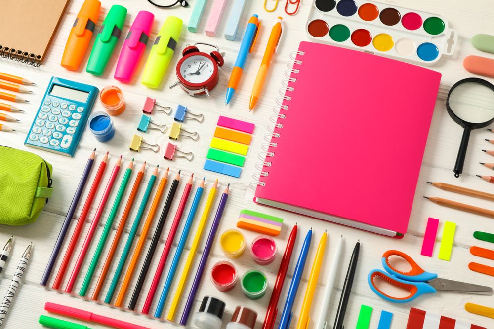 Flat lay composition with school supplies on wooden background