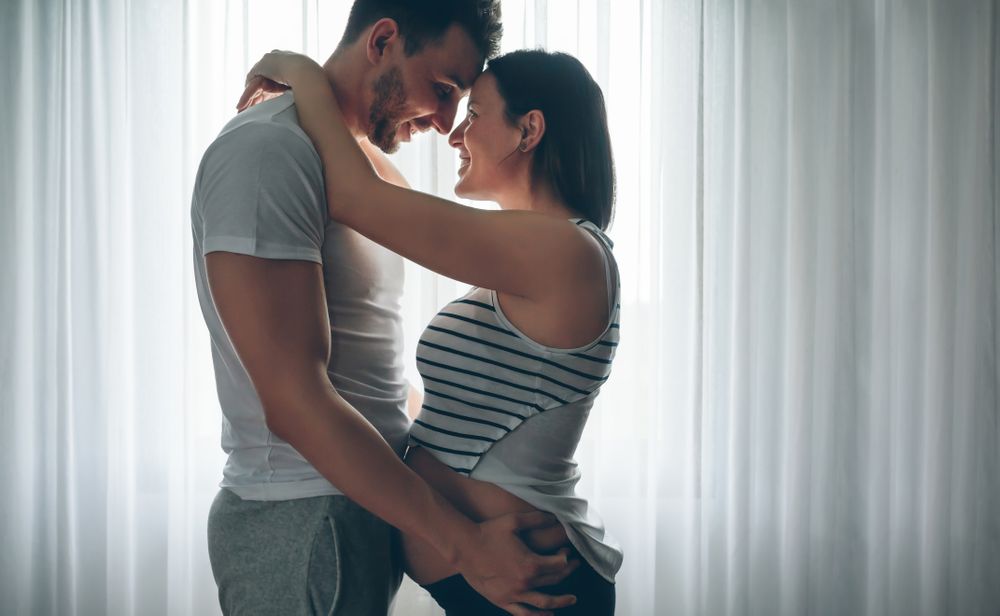 Man embracing his pregnant partner