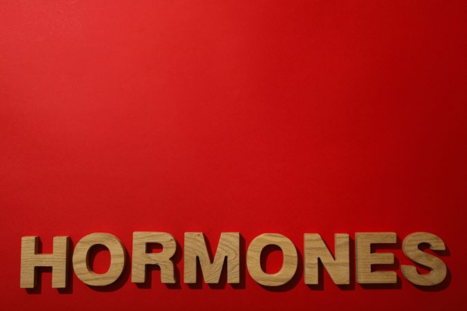 The word hormones on a light background.