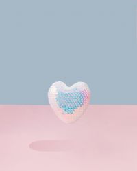 Iridescent sequins heart on and pink background