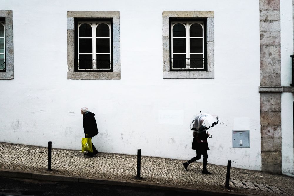 Two people walking on sidewalk
