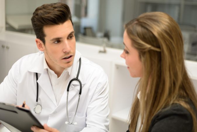 Male doctor with female patient in clinic