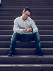 Man checking time on stairs