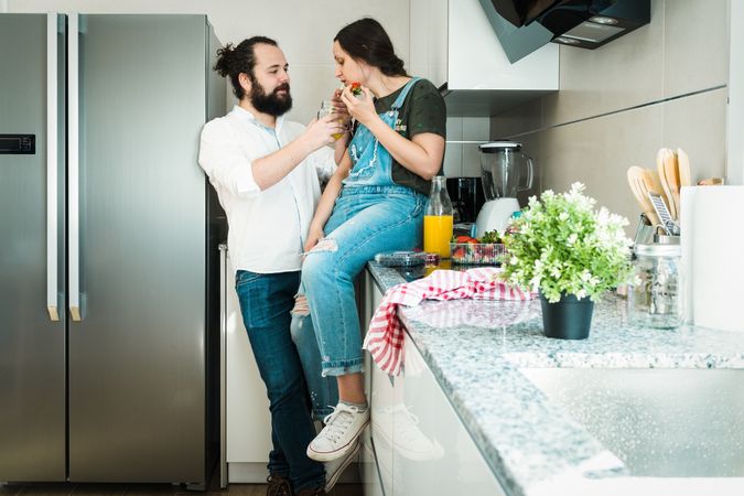 Couple eating healthy food in kitchen