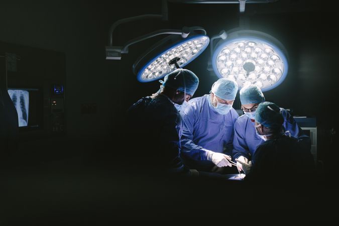 Medical team performing surgery in operation room
