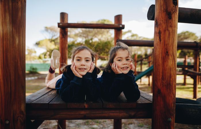 Twin sisters having fun at playground