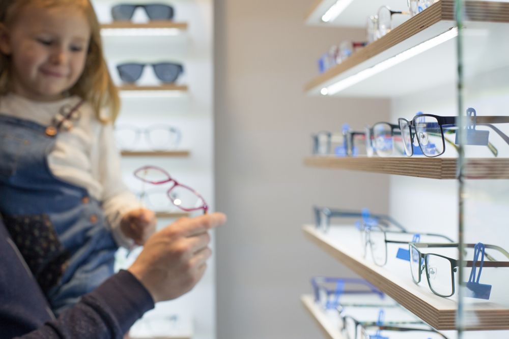 Young girl trying on glasses