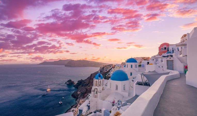 Colorful sunset in Santorini with views of the town and sea