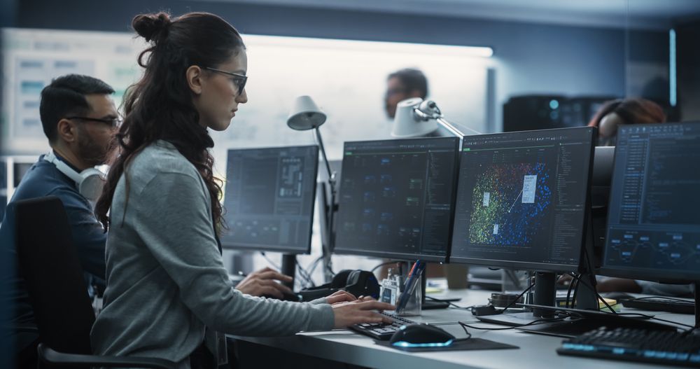 Young Female Artificial Intelligence Engineer Working on Computer in a Technological Office.