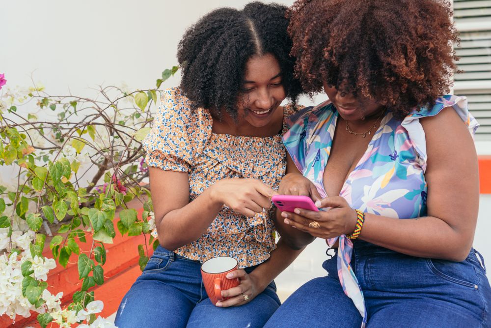 Two Friends Using Smartphone On the Street