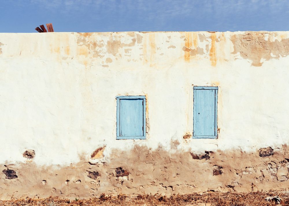 Closed window in rustic wall of old house