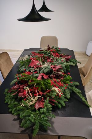 Christmas floral composition of spruce branches and red leaves