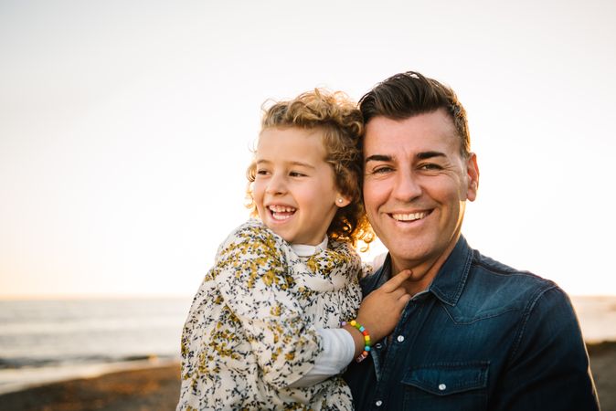 Father with her daughter at beach