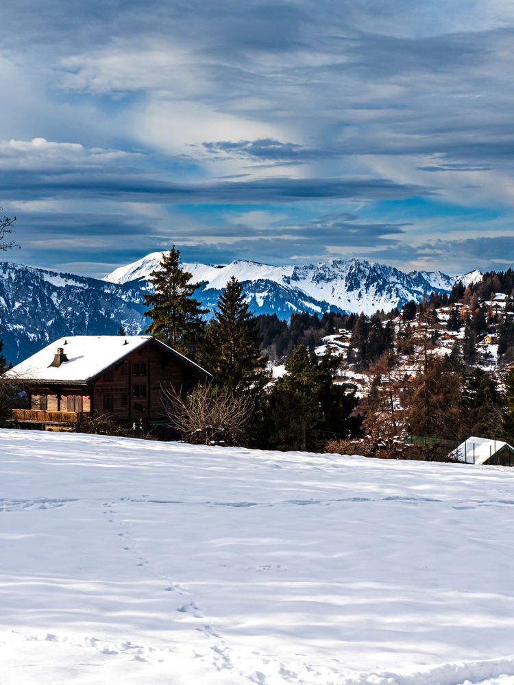 Swiss Alps winter landscape with snow and sun, mountains in Europe