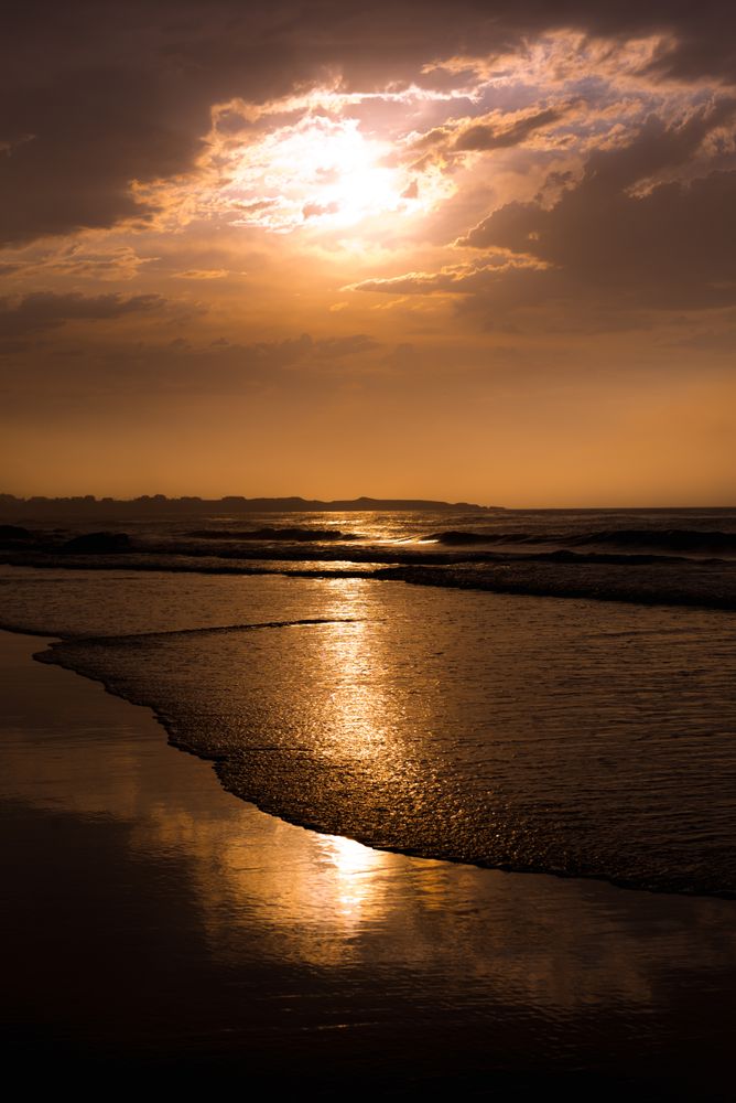 Beautiful evening sky over waving sea and shore