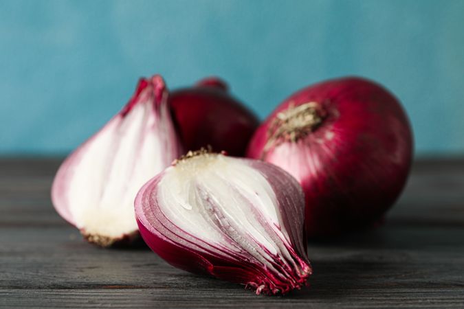 Composition with red onion on wooden table