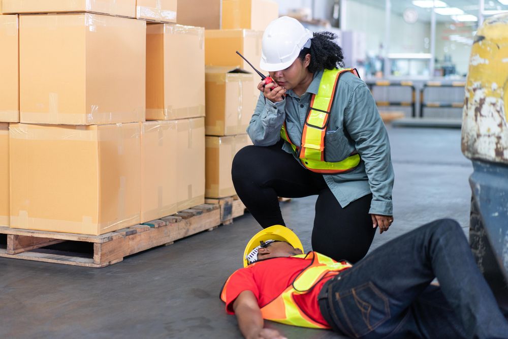 Black male in PPE gear passed out on distribution center floor