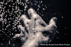 Grayscale photography of left human hand with water drops bDA280