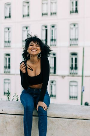 Fashionable Black female relaxing in city