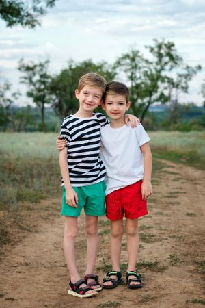 Two little brothers walking in countryside
