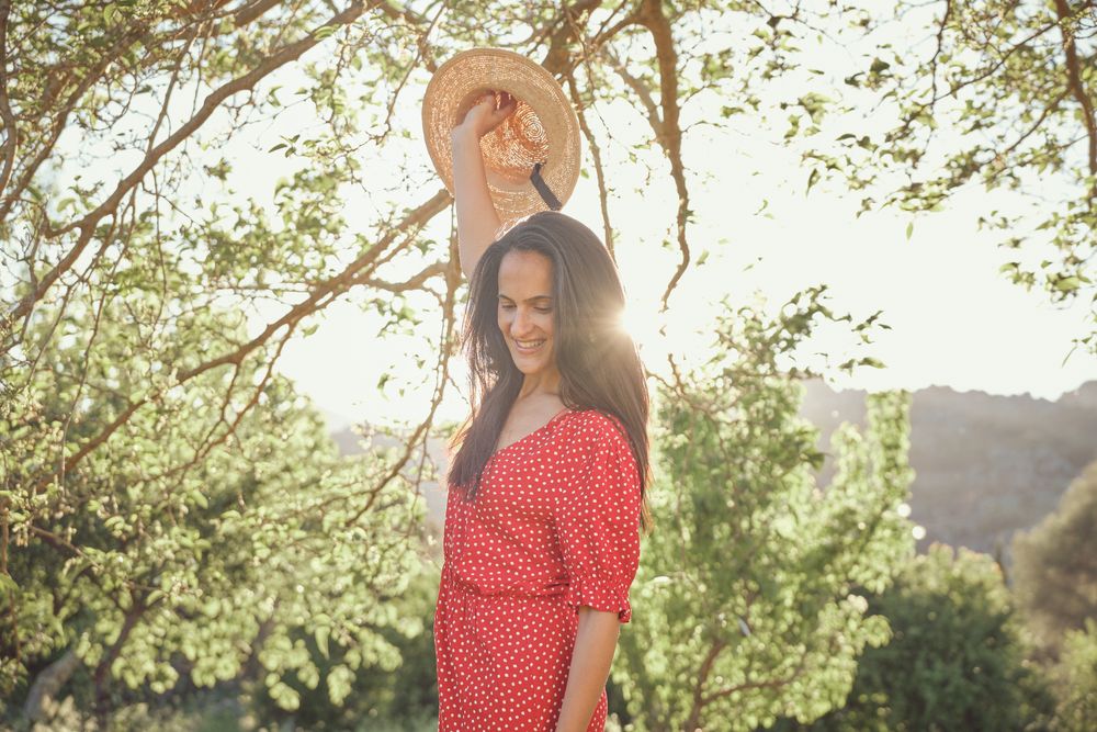 Smiling woman in summer dress in park