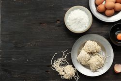 Top view of egg noodles and ingredients on table with space for text