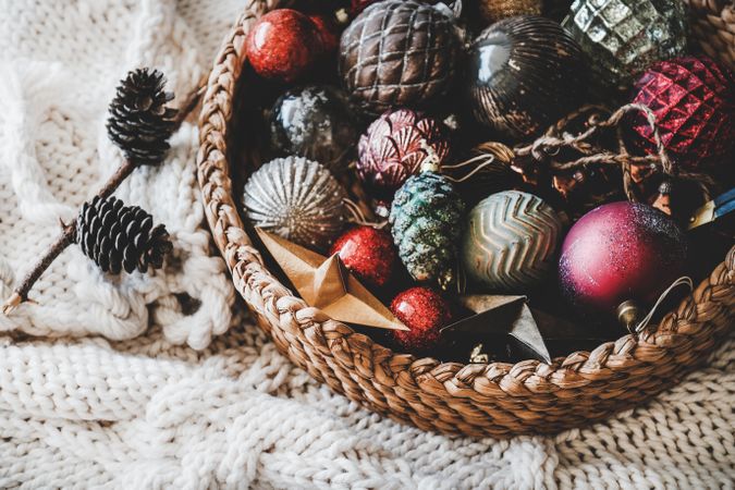 Christmas glass festive decoration toys and balls in basket, close up, top view