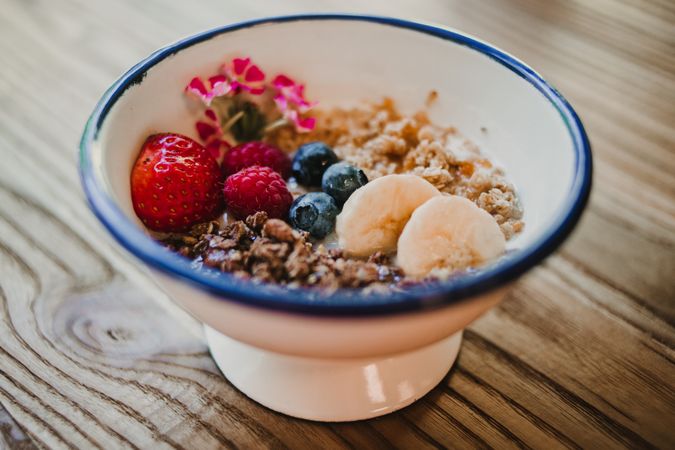 Ripe red strawberry blueberry and cereals in bowl