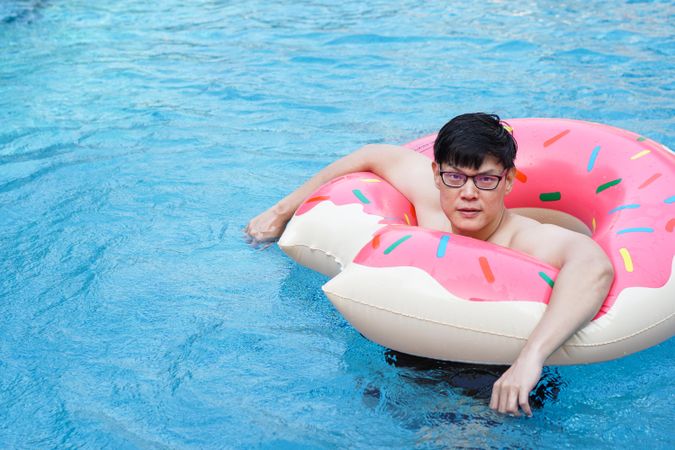 Asian man with swim ring