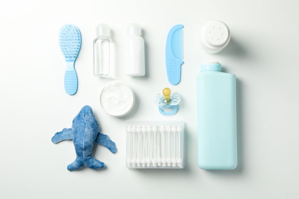 Flat lay with baby hygiene accessories on light background
