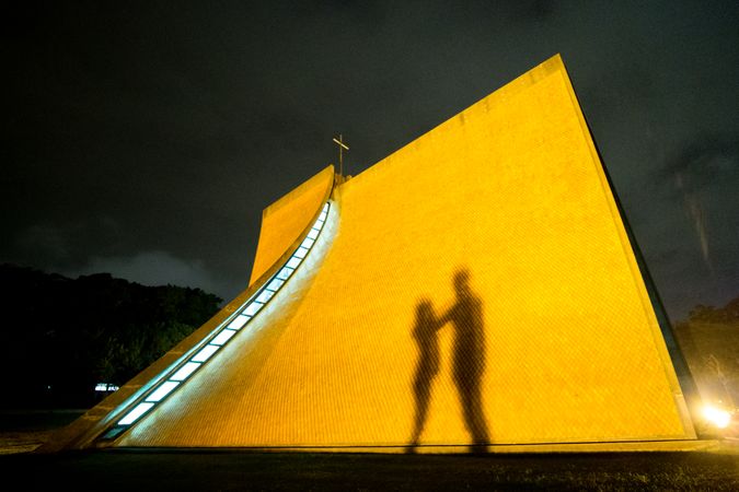 Shadow of man and woman on yellow building