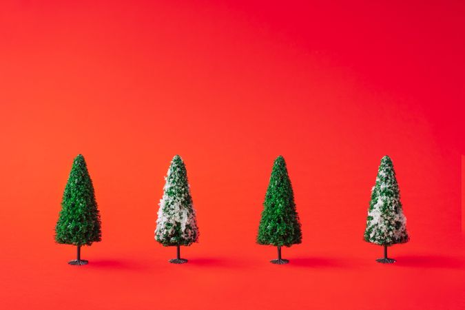 Snowy Christmas trees on red background