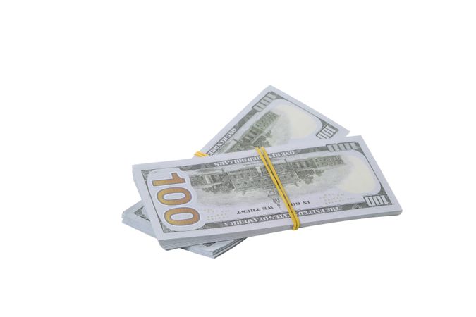 Stacks of American cash money, isolated on light background