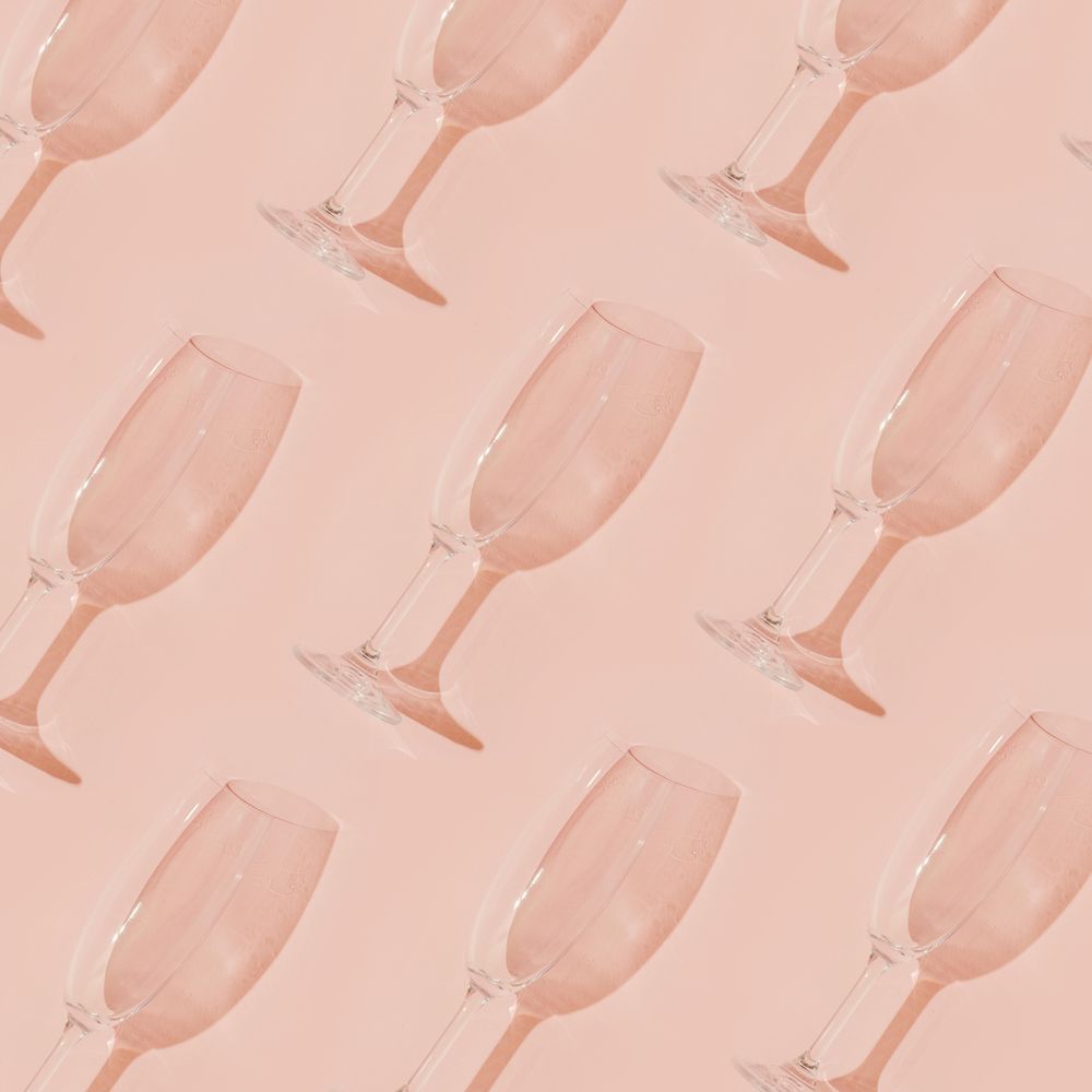 Champagne glass pattern on pastel coral background