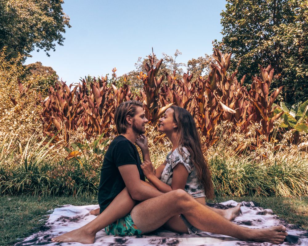 Man and woman hugging and sitting on ground