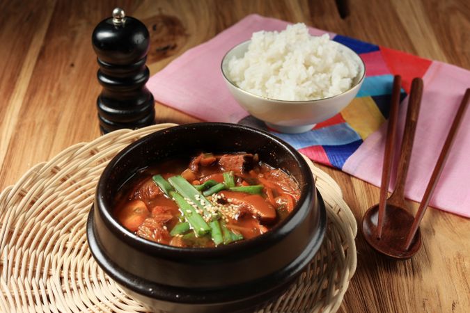 Kimchi soup in hot iron pot served with rice