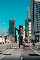 Woman with afro hair walking through the streets