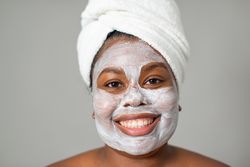 Black female with clay mask