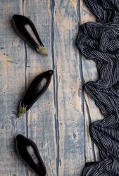 Ripe eggplants on shabby tabletop