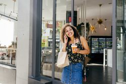 Cheerful woman leaving restaurant