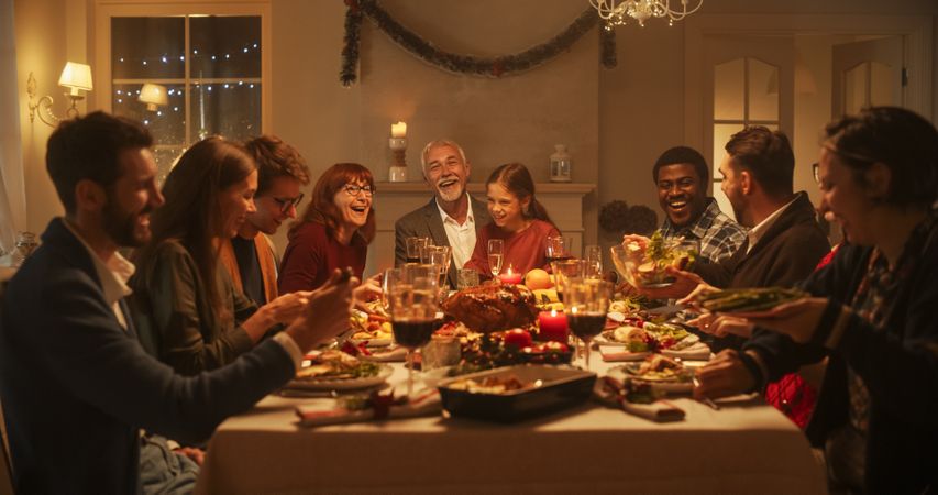 Multi-Generational Family Members Share Funny Stories and Joy During a Christmas Turkey Dinner.