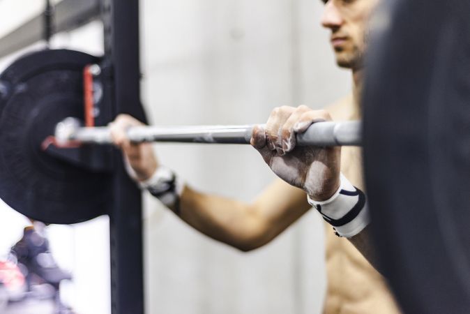 Man training with barbell in gym