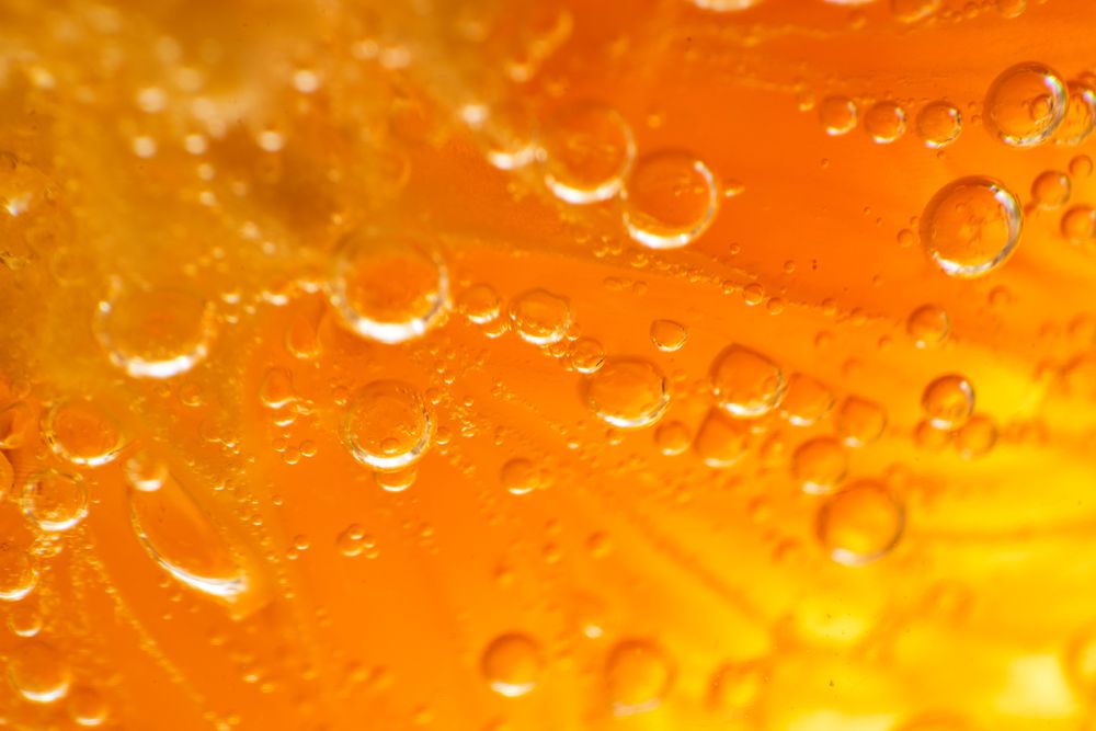 Orange in gin and tonic alcoholic cocktail